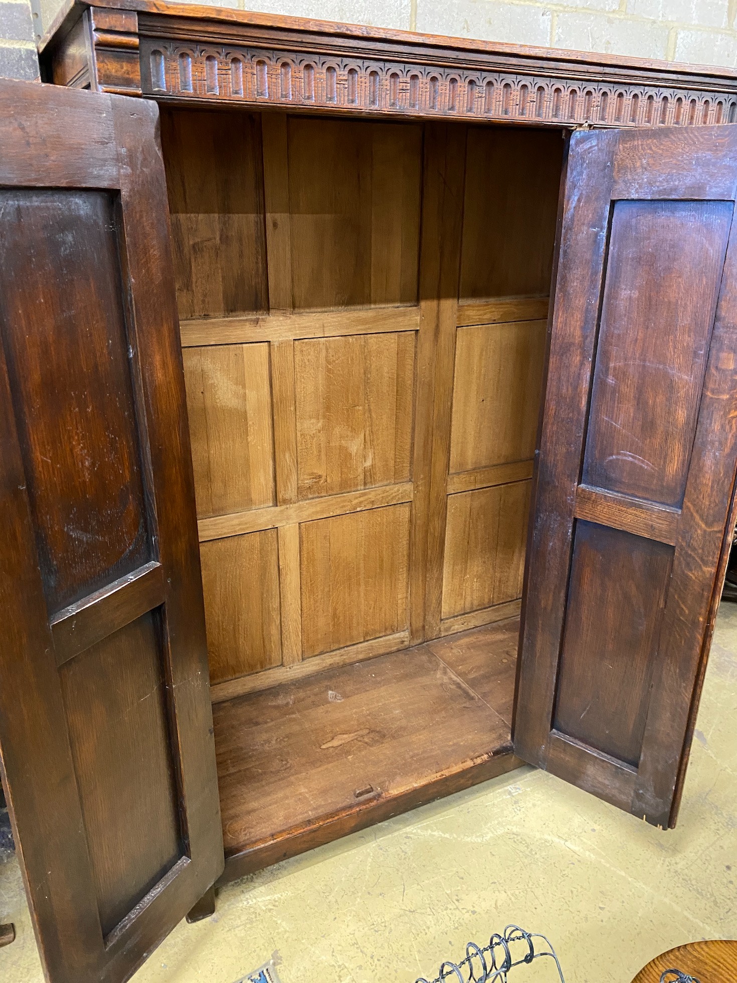 A 17th century style oak three door wardrobe, width 150cm, depth 61cm, height 183cm